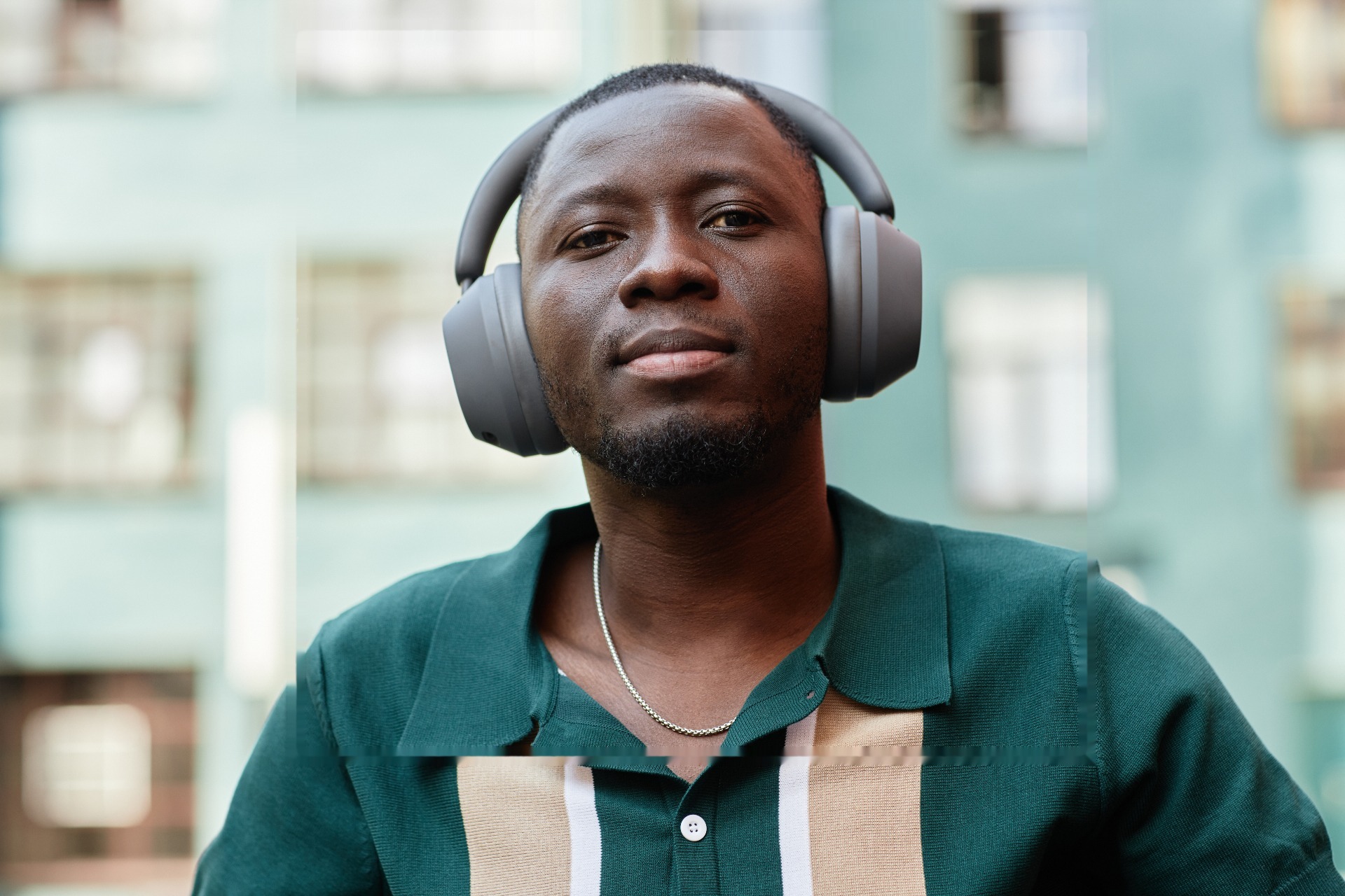 Man wearing headphones looking calm and focused outdoors